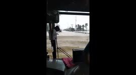 Bus drives through floodwater after Typhoon Nakri hit the Philippines