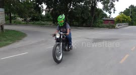 Motorcycle Rider Wears Bright Green Predator Helmet