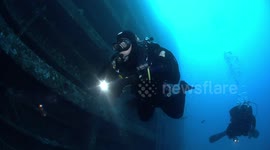 Scuba divers exploring Zenobia wreck
