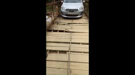 The driver risked his life to drive the car across the damaged bridge