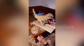 Chinese repairman creates dinosaur model from hundreds of peanut shells