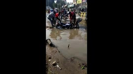 Motorcycle fished out of giant flooded pothole on north Indian road