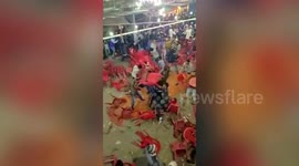 Shocking moment audience hurl chairs at one another during cultural event in northern India