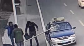 Worker in China accidentally impales steel pipe into passing taxi