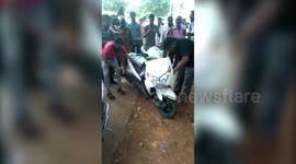 Locals rescue snake that was stuck inside scooter in southern India