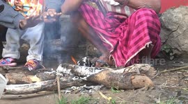 Mountain tribe keeps warm with log fire as temperatures drop in northern Thailand