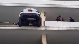 World's worst parking! Driver hits reverse and smashes through 50ft-high concrete wall