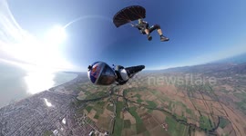 This is the moment a skydiver used his friend as a human SURFBOARD - 15,000ft above the Earth