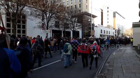 thousands of people walking through Bristol city to protest against Black Friday consumerism and climate change