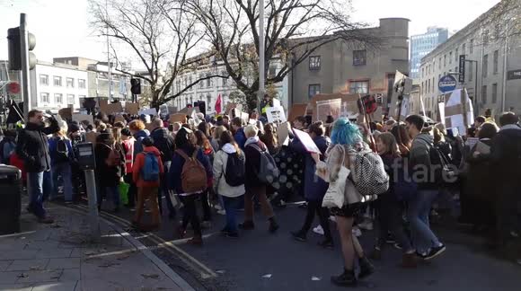 thousands of people walking through Bristol city protesting against climate change and Black Friday consumerism