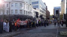 thousands of young people protesting in Bristol at climate change, walking through city, holding up buses, carrying banners and chanting act now
