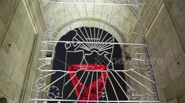 Huge red bow draped from Madrid monument for World Aids Day