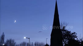 Time Lapse of Moon Setting Behind Church - Festive Scene