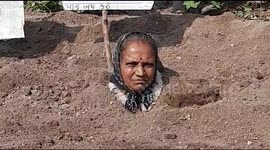 Family of farmers bury themselves up to their necks to demand government compensation