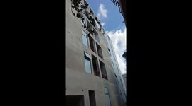 The painters are like spiders man working on tall buildings