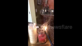 Candle mysteriously relights from residual smoke after being blown out