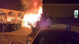 This is the moment flames billowed out of a London Travelodge hotel before the blaze was tackled by 100 firefighters