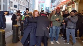 Salvation Army officer dancers with passerby in New York