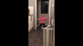 Cute girl waits outside toilet for her dad