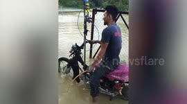 Mechanics have wacky modified motorcycle for riding through floods in Malaysia