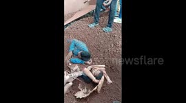 Couple in India rescued after truck dumps mineral ore cargo on them