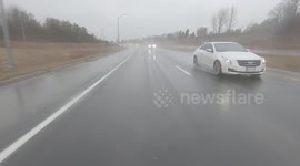 Mild temperatures and heavy rain made for poor visibility for drivers on highway 401 west of Toronto in southern Ontario today as the weather oscillates from cold to mild to cold again in Canada