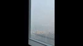 Bushfire smoke blankets sky outside office block in Sydney