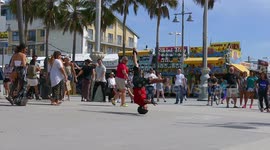 Guy performs an incredible head spin in Venice beach California