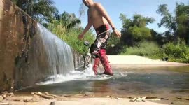 Motorcycle Rider Cools Off In Mini Waterfall