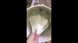 Oddly satisfying clip shows painter peel dried paint from bucket in one piece