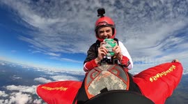 Amazing footage shows US skydiver tucking into burger while hurtling through the air on wingsuiter's back