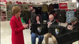 Moment Nicola Sturgeon stopped her weekly shop in Asda -- to conduct a brass band playing Christmas tunes for charity