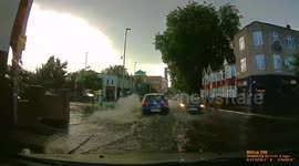 Unfortunate UK driver makes mistake of having window down on a flooded road