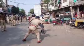 Horrific footage shows minor girl getting caught in crossfire as cops open fire to scare away violent protesters in western India