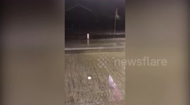 UK man washes car at petrol station despite torrential rainstorm