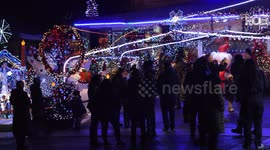 Feeling that warm glow yet? Crowds in Toronto gather at a house covered with THOUSANDS of Christmas lights