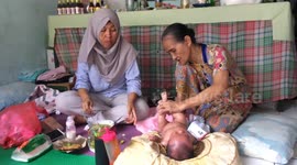Controversy over traditional healer treating baby in Indonesian slum