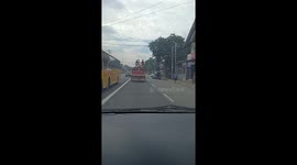 Filipino teenagers stand on top of moving truck