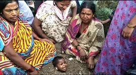 In a superstitious belief Disabled kids buried  neck deep in cow dung and mud pit on solar eclipse day in Kalburgi