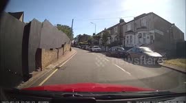 Audi overtakes a learner that is waiting for a bus then a stolen scooter riders ride on the pavement to overtake everyone waiting