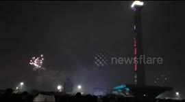 the atmosphere of visitors celebrating the turn of the year at the national menumen in the rain in Jakarta. Indonesia