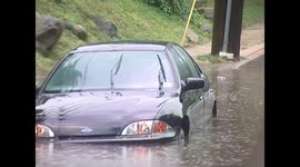 Car gets stuck in high water under bridge after thunderstorms come through area