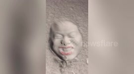 Chinese man dunks his head into deep snow creating hilarious face prints
