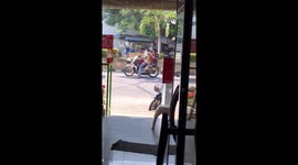 Couple Ride Motorcycle With Pet Dog Between Them