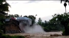 House collapses into river below after heavy downpour in Indonesia
