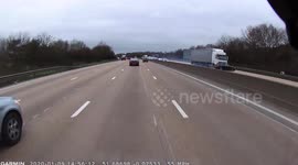 Shocking moment truck smashes into car and drags it across UK motorway