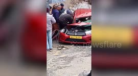 Car crushed by huge boulders while driving on north Indian mountain road