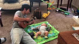 Teen serenades baby nephew with ukulele in sweet scene