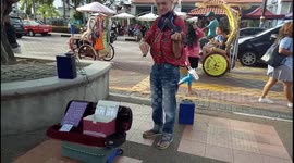 Mister Christian performs with his magic violin at street around the world for over 40 years