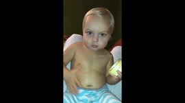 Adorable toddler is occupied with putting on her ointment.